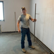 Mason poses with tools during the first week of the renovation