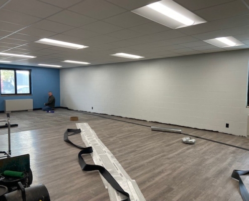 Flooring and baseboard installation in Beginners classroom